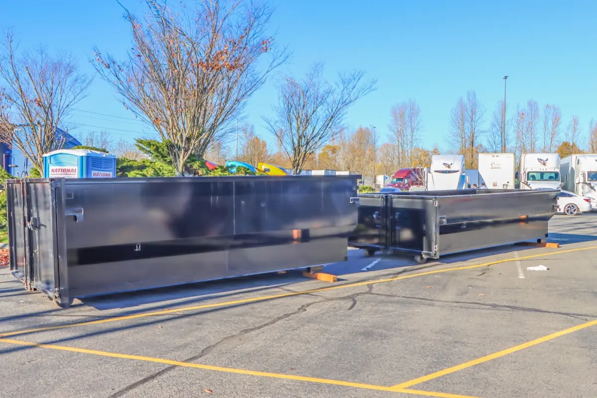 Professional dumpster rental service with roll-off container on residential driveway in Sunset Hills